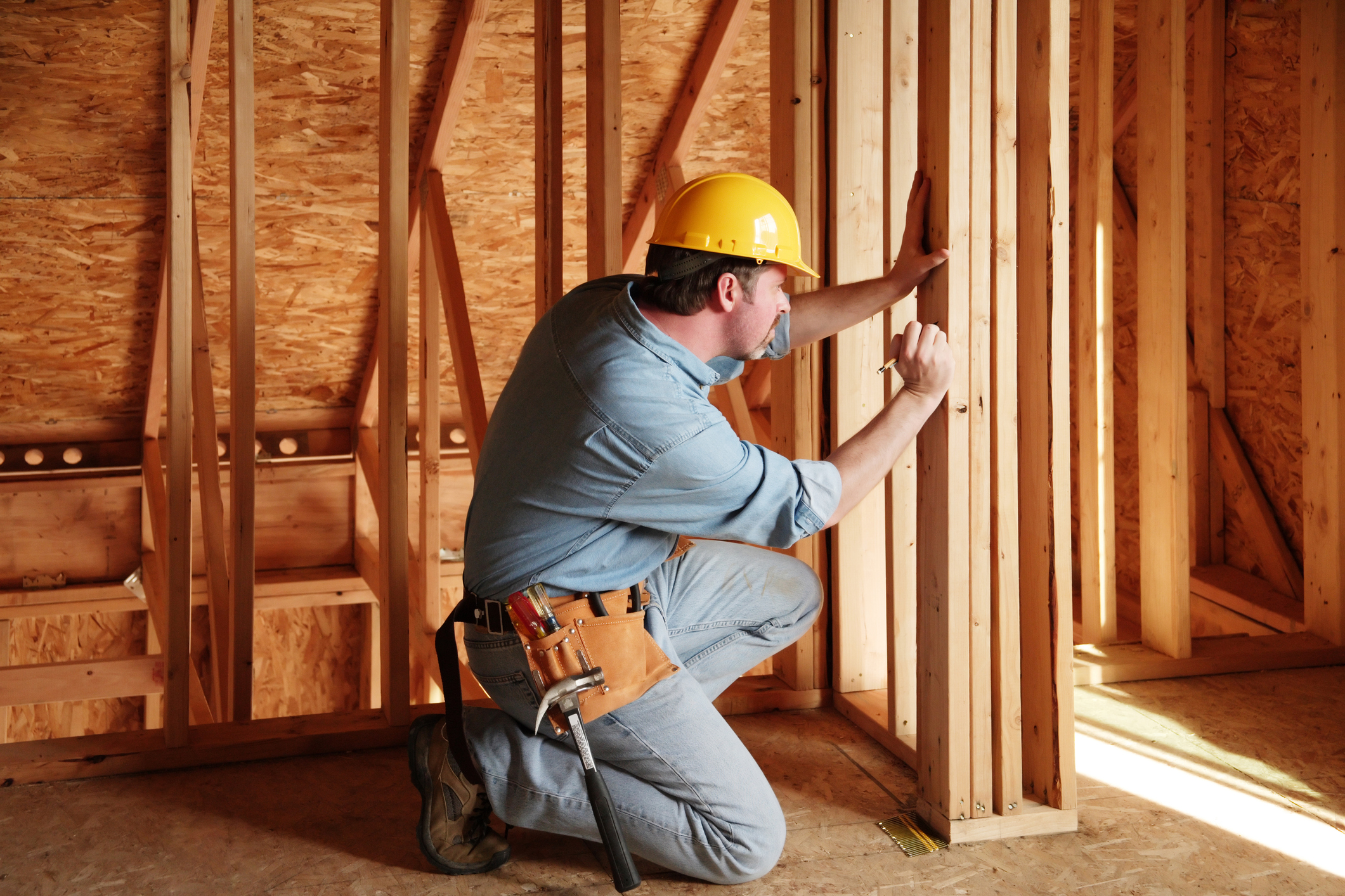 new home construction engineer verifying a measurement